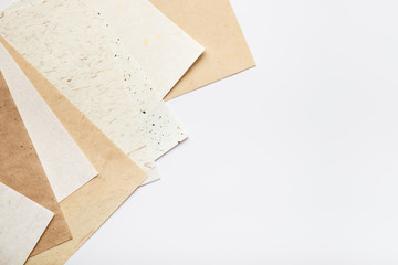 Stack of different handmade paper on a white background