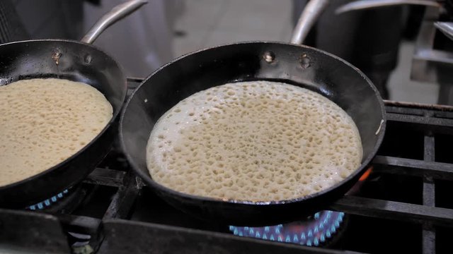Close up. Chief cooking classical Jewish Yemenite food. Lachuch is a traditional Yemenite pita. Tsfat. Israel. Cosy and bright kitchen of a street restaurant