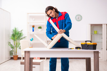 Young male carpenter working indoors