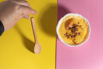 delicious custard in yellow and pink background