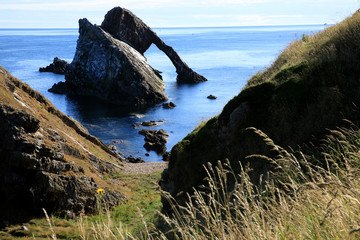 Portknockie (Scotland), UK - August 01, 2018: Bow Fiddle Rock sea arch, Portknockie, Scotland, Highlands, United Kingdom
