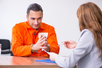 Young man meeting with advocate in pre-trial detention