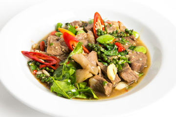 spicy stir fired beef oyster sauce with pepper seeds kaffir lime leaves sato and paprika chili serve on white plate