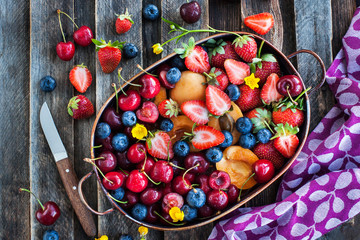 Fresh ripe summer berries and fruits (cherry, strawberry, blueberry, apricots)