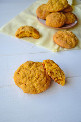 Home made carrot cookies on a white kitchen table.