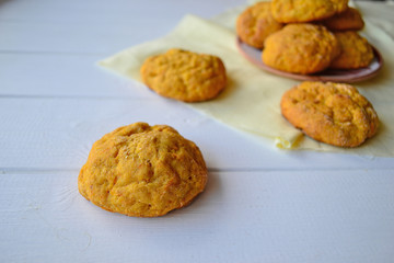 Home made carrot cookies on a white kitchen table.