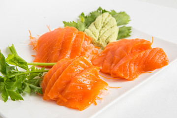 raw fresh salmon serve in white plate with wasabi