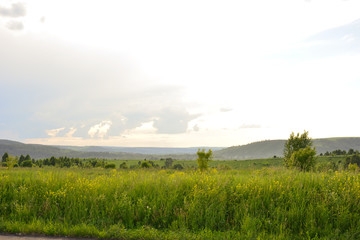 Summer landscape against the sky with clouds at sunset