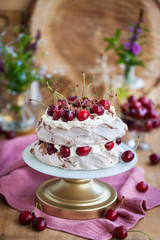 Delicious Black Forest Pavlova meringue cake with fresh cherry