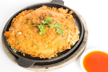 crispy fried shell pancake in hot pan serve with thai sriracha sauce