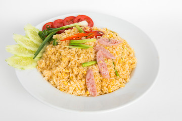 thai fired rice with fermented pork eat with  cucumber tomato and spring onion serve in white plate