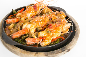 big prawns top with hot and spicy sauce serve in hot plate