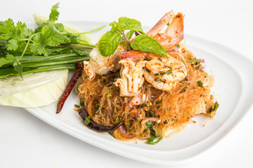 larb clear noddle spicy mixed  seafood salad eat with fresh vegetables looks spicy serve in white plate