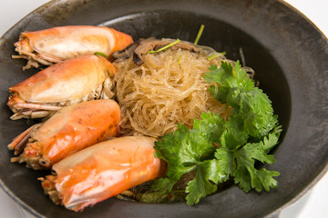 casseroled prawns with glass noodles  top with shitake mushrooms and coriander serve in black pot