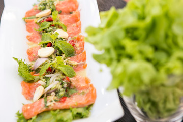 fresh raw salmon tip with spicy thai sauce eat with vegetable