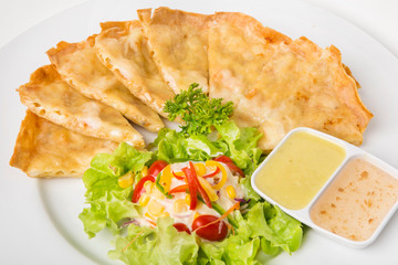 crispy shrimps pancake thai food called "goong gra buang" serve with salad and eat with  thai sweet and plum sauce 