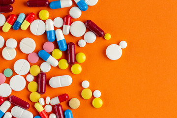 A lot of colorful medication and pills from above. Pharmaceutical industry concept. Antibiotic drug...