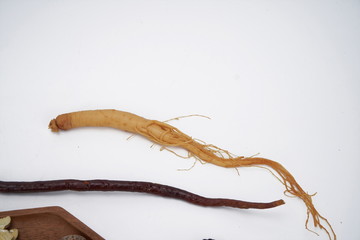 Chinese medicine and herbs are in wooden trays, they are in a white background. Chinese prescription close-up Top view