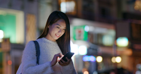 Businesswoman use of mobile phone at night