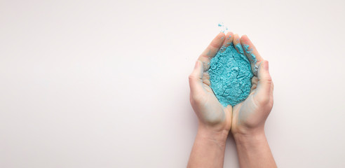 Blue powder paint in hands for Holi