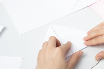 Origami is an ancient Chinese art of folding paper. Young woman doing a stick figure