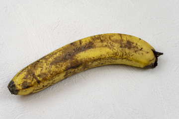 Old spoiled banana on a white background