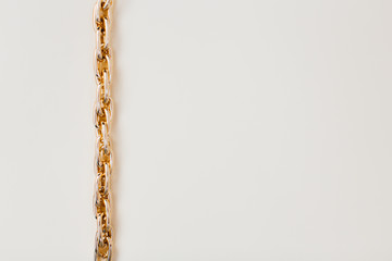 massive golden braided chain bracelet on a white background in isolation copy space place text