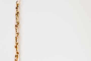 massive golden braided chain bracelet on a white background in isolation copy space place text