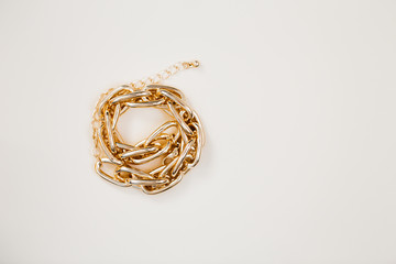 massive golden braided chain bracelet on a white background in isolation copy space place text