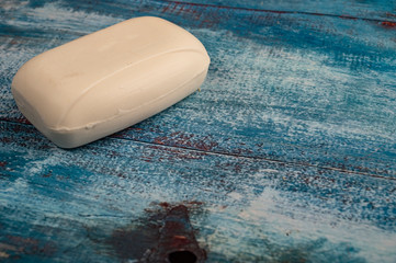 A piece of toilet soap on a wooden background. Close up. Clean hands prevention of COVID-19...
