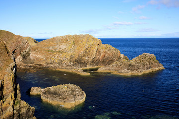 Portknockie (Scotland), UK - August 01, 2018: Coastal landscape at Bow Fiddle Rock sea arch, Portknockie, Scotland, Highlands, United Kingdom