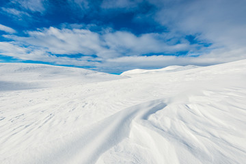 Fototapeta na wymiar Snowdrift on mountain landscape, Norway.