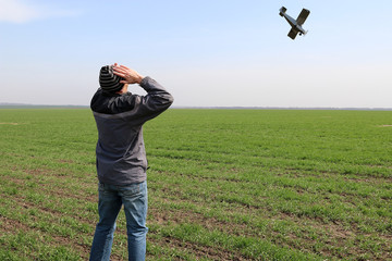 Farmer on his wheat field. A farmer sees a small plane falling over a field.