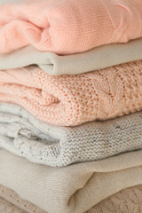 Stock Photo - Stack of cozy knitted sweaters