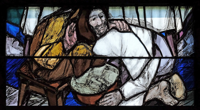 God begins salvation in this world through His Son Jesus Christ, detail of stained glass window by Sieger Koder in St. John church in Piflas, Germany