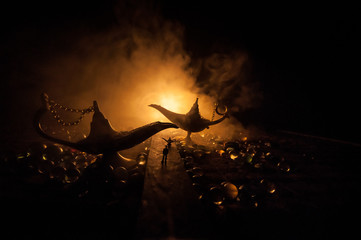 Silhouette of a man standing in the middle of the road on a misty night with giant Antique Aladdin...