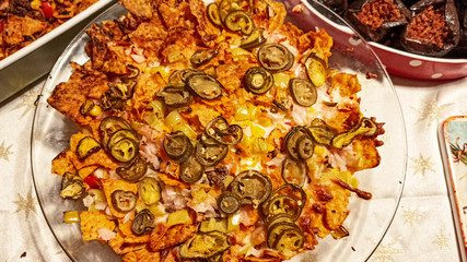 Mexican nachos tortilla chips with cheddar and jalapeno. Homemade  traditional mexican food served with cheddar cheese and jalapenos. 