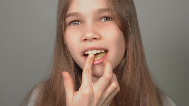 teenage girl eating French fries closeup.