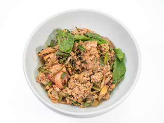 The close up of Spicy minced pork salad in white bowl on white table.