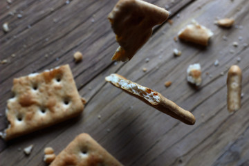 texture cookies on a blurry background falling on a wooden table