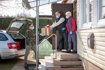 A volunteer / soldier brought food for senior citizens