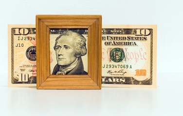 portrait of ten dollar bill in wooden frame