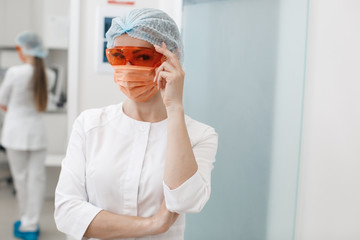Medical doctor working in research lab. Science assistant making experiments. Laboratory tools: microscope, test tubes, equipment. Chemistry, medicine, biochemistry and healthcare.Covid-19 concept.