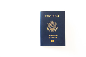 Naklejka premium Latest version of United States of America citizen Passport with biometric ID chip. Person identification document isolated on white. Close up, copy space, background.