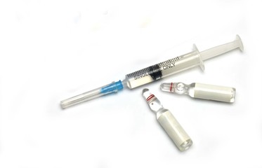 medical syringe and ampoules with medicine on a white