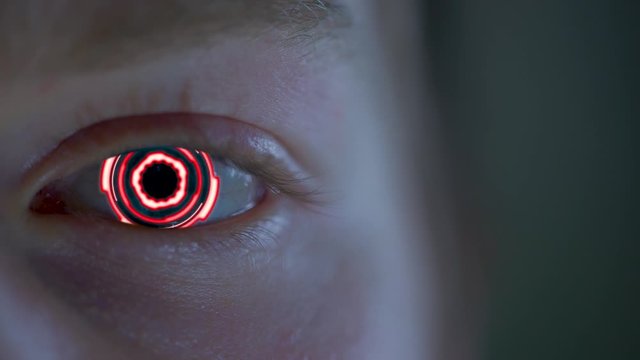 Bright red bionic eye looking at you - close up
