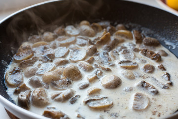 mushrooms in a creamy sauce in a pan. Homemade cooking.