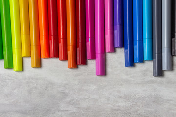 Obraz premium Multi-colored markers for drawing, tools for children's creativity top view on a gray background, copy space, close-up