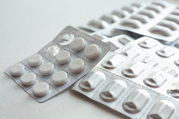 pills in blister isolated on white background. pills on white background. Top view. white tablets...