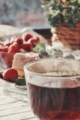 Fresh delicious dessert with berries and green decoration, sweet food, tea time, focused on tea